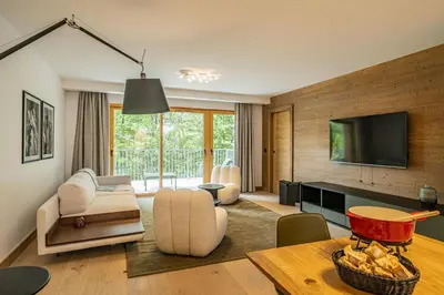 a living room with a couch and a tv at Paradisa Mer de Glace Elegant brand new 3-bedroom apartment in Chamonix-Mont-Blanc