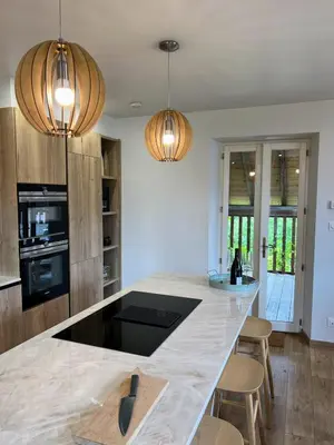 a kitchen with a counter and two pendant lights at Chalet Tomsine in Samoëns
