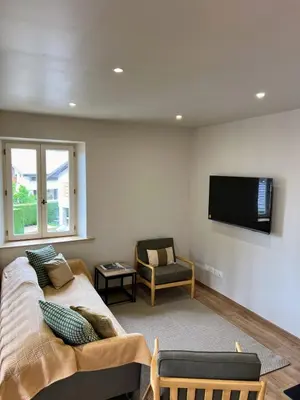 a living room with a couch and a flat screen tv at Chalet Tomsine in Samoëns
