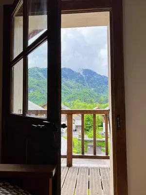 an open door with a view of a mountain at Chalet Tomsine in Samoëns