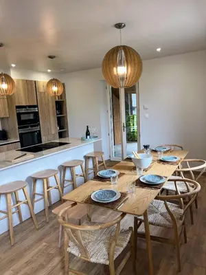 a kitchen and dining room with a wooden table and chairs at Chalet Tomsine in Samoëns