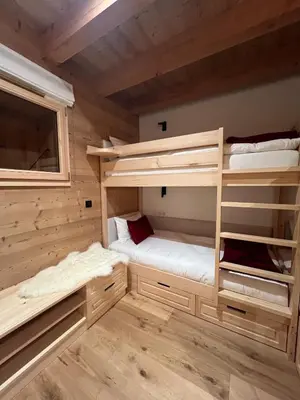 a room with two bunk beds in a cabin at Chalet 180 I Le Chalet Club in Combloux