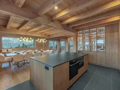 a kitchen and dining room with a table and chairs at Chalet 180 I Le Chalet Club in Combloux