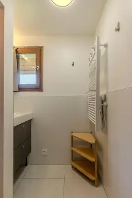 a bathroom with a sink and a shelf and a mirror at Appartement avec superbe vue montagne in Arâches-la-Frasse