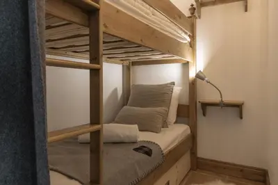 a bunk bed in a small room with a lamp at Grande Jorasses 2 - Ski - Terrasse - Vue Montagne in Les Houches
