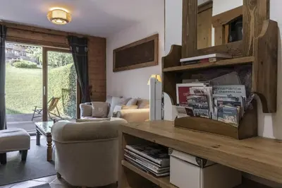 a living room with a table and a couch at Grande Jorasses 2 - Ski - Terrasse - Vue Montagne in Les Houches