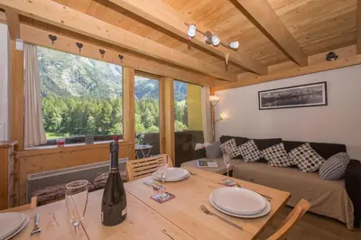 a building in the snow in front of a mountain at Résidence Grand Roc - Bruyères 220 - Happy Rentals in Chamonix-Mont-Blanc