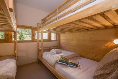 a bedroom with a bed with towels on it at Résidence Grand Roc - Bruyères 220 - Happy Rentals in Chamonix-Mont-Blanc