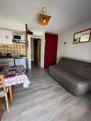 a room with a bed and a table and a kitchen at Studio Contamines-Montjoie in Les Contamines-Montjoie