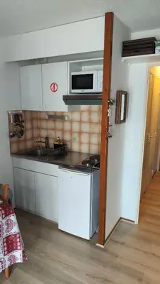 a kitchen with a stove and a microwave at Studio Contamines-Montjoie in Les Contamines-Montjoie