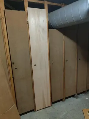 three wooden doors in a room with a pipe at Studio Contamines-Montjoie in Les Contamines-Montjoie