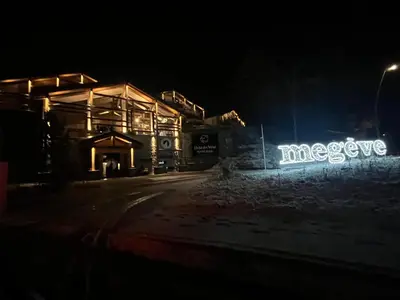 a building with neon signs on it at night at Megeve Praz sur Arly Apparthotel eclat des veriaz Studio vue sur jardin in Megève