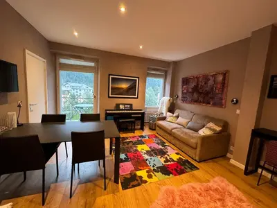 a living room with a table and a couch at Chamonix city center rue Paccard in Chamonix-Mont-Blanc