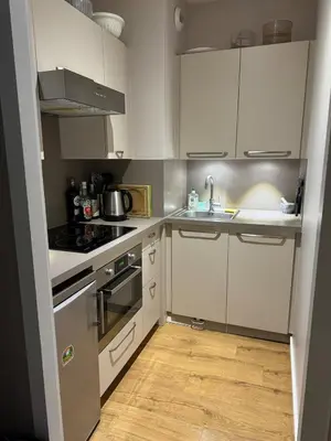 a small kitchen with white cabinets and a sink at Chamonix city center rue Paccard in Chamonix-Mont-Blanc