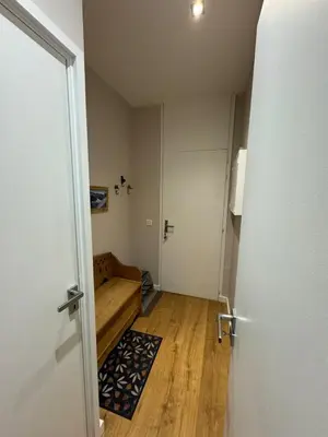 a small room with a couch and a door at Chamonix city center rue Paccard in Chamonix-Mont-Blanc