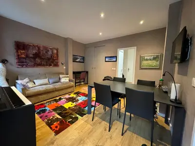 a living room with a table and a couch at Chamonix city center rue Paccard in Chamonix-Mont-Blanc