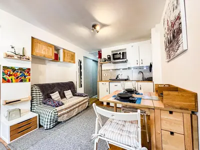 a living room with a couch and a table in a room at Studio 4810 Centre Chamonix in Chamonix-Mont-Blanc