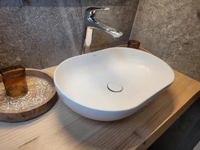 a white sink on top of a wooden counter at Le Top des Praz in Chamonix-Mont-Blanc
