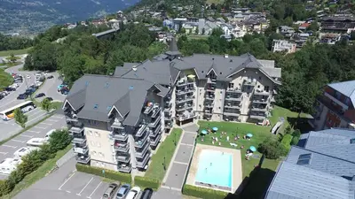 an aerial view of a large apartment building with a pool at Grand Panorama 1 bedroom - sleeps 4, Parking, Pool, Next to Ski Lift in Saint-Gervais-les-Bains