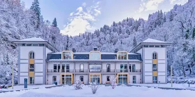 a large white house with snow covered trees at Grand Panorama 1 bedroom - sleeps 4, Parking, Pool, Next to Ski Lift in Saint-Gervais-les-Bains