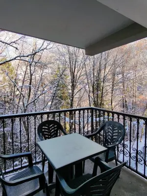 a table and chairs on a balcony with a view at Grand Panorama 1 bedroom - sleeps 4, Parking, Pool, Next to Ski Lift in Saint-Gervais-les-Bains