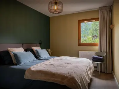 a bedroom with a bed and a window at Lodge Sami - OVO Network in Samoëns