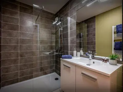 a bathroom with a sink and a shower and a tub at Lodge Sami - OVO Network in Samoëns