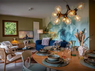 a living room with a table and a dining room at Lodge Sami - OVO Network in Samoëns