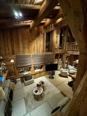 an overhead view of a living room with wooden walls at Chalet de Luxe - Centre-Ville in Megève