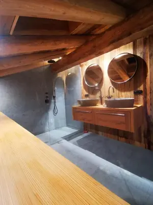 a bathroom with two sinks and two mirrors at Chalet de Luxe - Centre-Ville in Megève