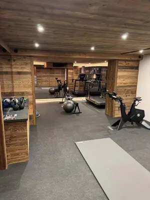 a gym with exercise bikes and exercise machines at Chalet de Luxe - Centre-Ville in Megève