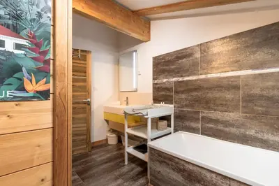 a bathroom with a tub and a sink at Chalet du Verney - Pied du Prarion - Sauna in Les Houches