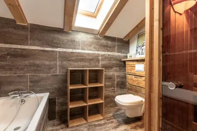 a bathroom with a toilet and a tub and a sink at Chalet du Verney - Pied du Prarion - Sauna in Les Houches
