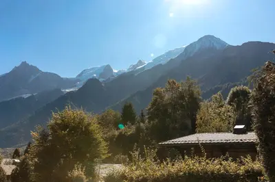 a view of mountains with a house in the foreground at Chalet du Verney - Pied du Prarion - Sauna in Les Houches