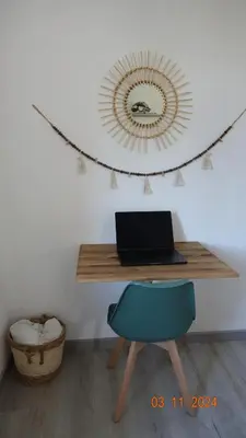 a desk with a laptop and a blue chair at La Comtesse in Saint-Gervais-les-Bains