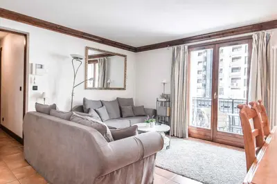 a living room with a couch and a window at Apartment Balmat - Chamonix All Year in Chamonix-Mont-Blanc