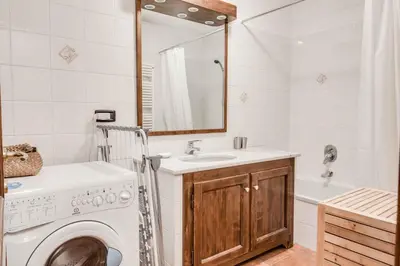 a bathroom with a washing machine and a sink at Apartment Balmat - Chamonix All Year in Chamonix-Mont-Blanc