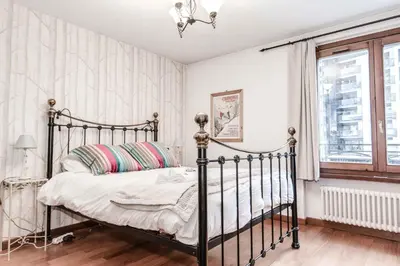 a bedroom with a metal bed and a window at Apartment Balmat - Chamonix All Year in Chamonix-Mont-Blanc