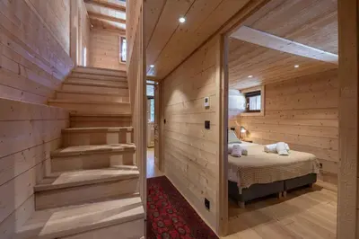 a room with a bed in a wooden house at Chalet Altiora in Chamonix-Mont-Blanc