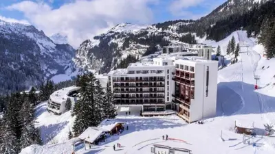 a building on top of a snow covered mountain at Résidence Le Panoramic - Appartement spacieux · Départ et retour skis aux pieds · Piscine · Parking inclus · Spa MAE-3063 in Magland