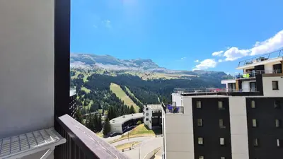a view of a mountain from a balcony of a building at Résidence Le Panoramic - Appartement spacieux · Départ et retour skis aux pieds · Piscine · Parking inclus · Spa MAE-3063 in Magland