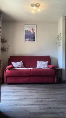 a red couch sitting in a living room at Résidence Telepherique - TELEPHERIQUE 8 MAE-2363 in Saint-Gervais-les-Bains
