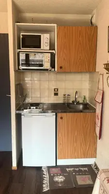 a kitchen with a stove and a microwave at Résidence Telepherique - TELEPHERIQUE 8 MAE-2363 in Saint-Gervais-les-Bains