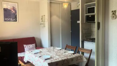 a table in a kitchen with a table and chairs at Résidence Telepherique - TELEPHERIQUE 8 MAE-2363 in Saint-Gervais-les-Bains