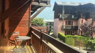 a balcony with a table and a view of a building at Résidence Telepherique - TELEPHERIQUE 8 MAE-2363 in Saint-Gervais-les-Bains