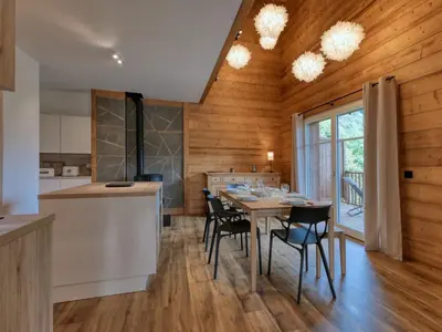 a kitchen and dining room with a table and chairs at Duplex moderne 5 pièces, 4 chambres, 10 pers., WiFi, parking, proche centre - FR-1-663-48 in Saint-Gervais-les-Bains