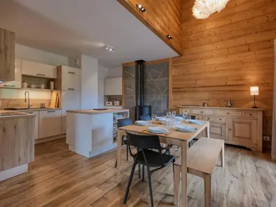 a kitchen and dining room with a wooden table and chairs at Duplex moderne 5 pièces, 4 chambres, 10 pers., WiFi, parking, proche centre - FR-1-663-48 in Saint-Gervais-les-Bains