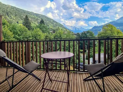 a living room with a white couch and wooden floors at Duplex moderne 5 pièces, 4 chambres, 10 pers., WiFi, parking, proche centre - FR-1-663-48 in Saint-Gervais-les-Bains