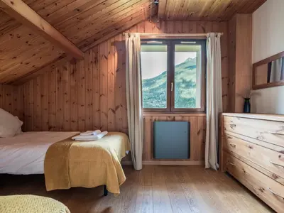 a bedroom with a bed and a window at Chalet Tannuaz - 4 Bedrooms - Quiet area - By Cozee Rentals in Les Houches