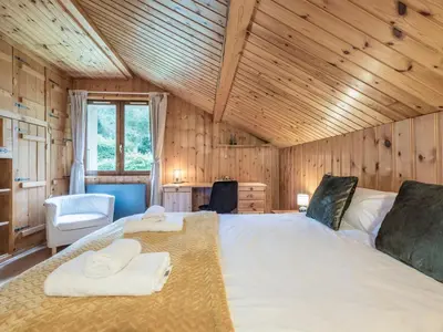 a bedroom with a large bed with towels on it at Chalet Tannuaz - 4 Bedrooms - Quiet area - By Cozee Rentals in Les Houches